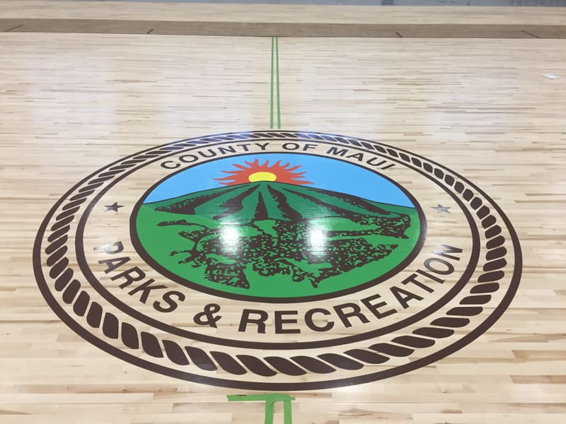 County of Maui Parks & Recreation seal painted on a gym floor
