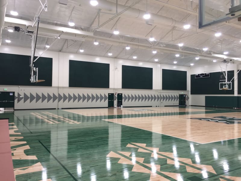 University of Hawaii gymnasium with painted court graphics and wall lettering