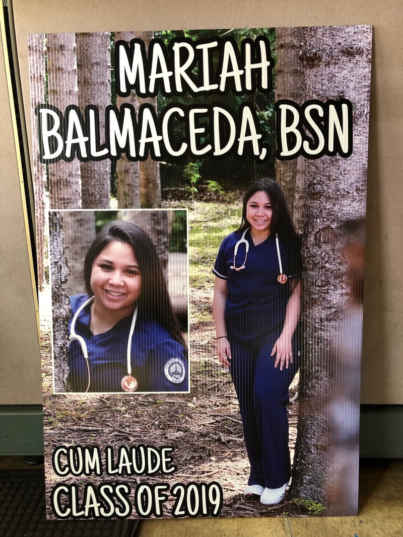 Custom graduation yard sign with a nursing graduate photo and class year