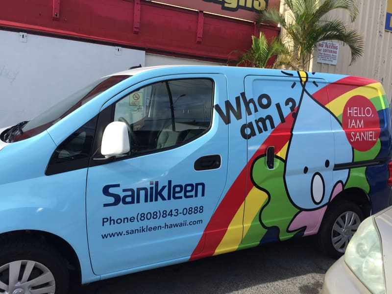 Sanikleen cargo van wrapped with rainbow artwork, logo, and phone number